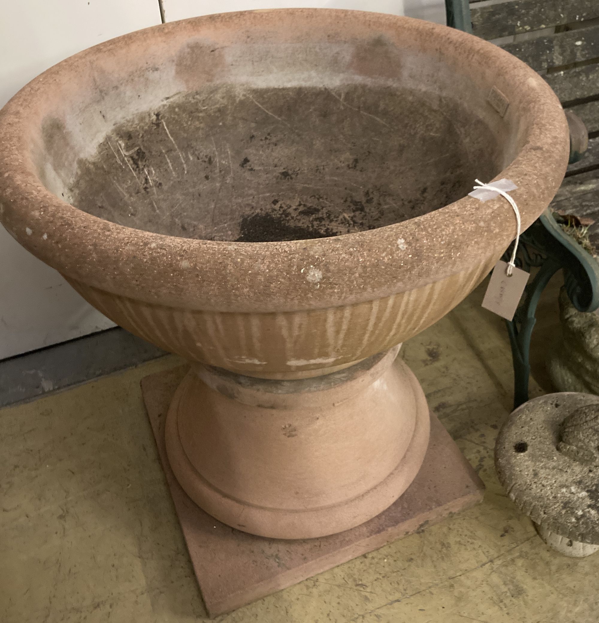 A large circular terracotta planter on base, named Kinsman, 70cm diameter, height 68cm